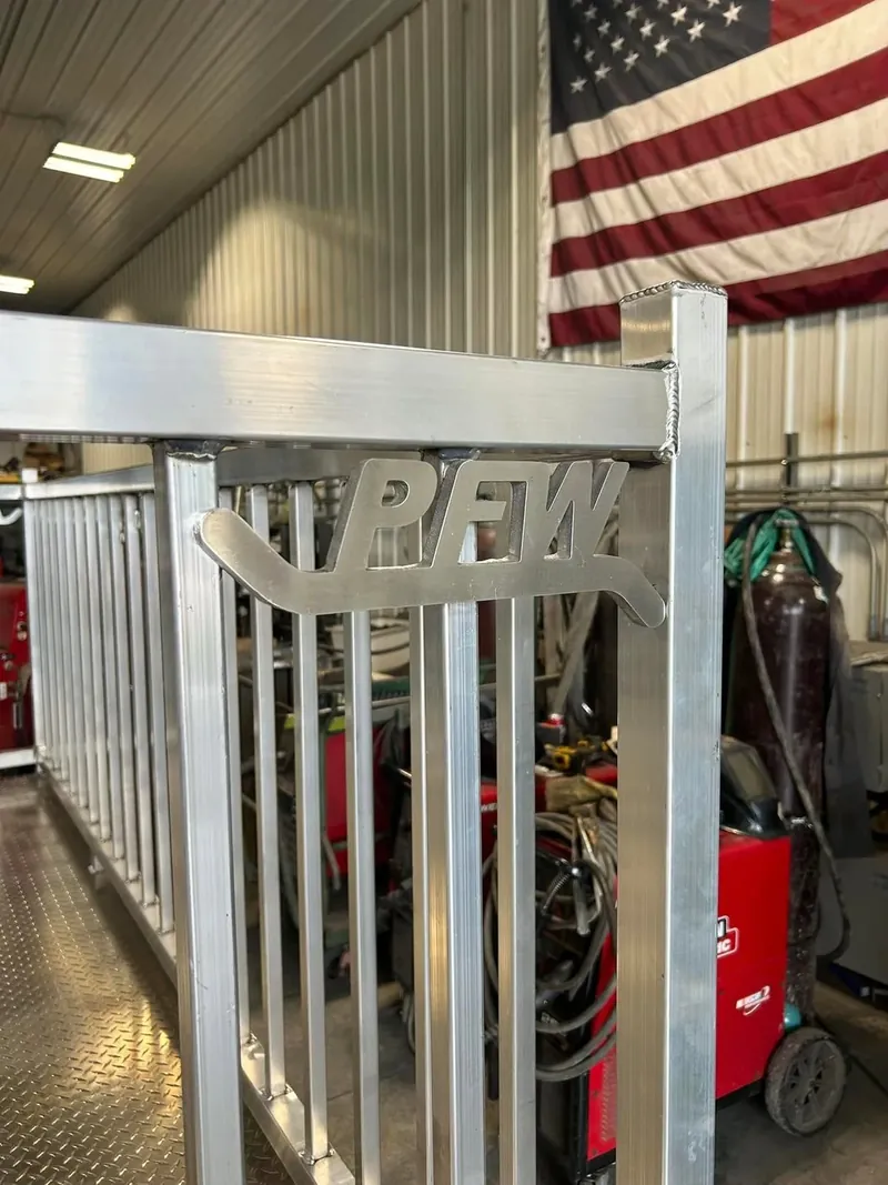 Plasma-cut PFW logo bracket welded into a custom aluminum railing