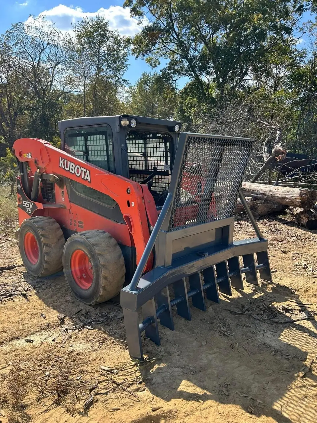 Skid steer root rake attachment in the field